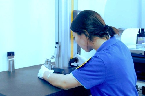 One of Gensun Precision's QC inspectors verifying the accuracy of a part