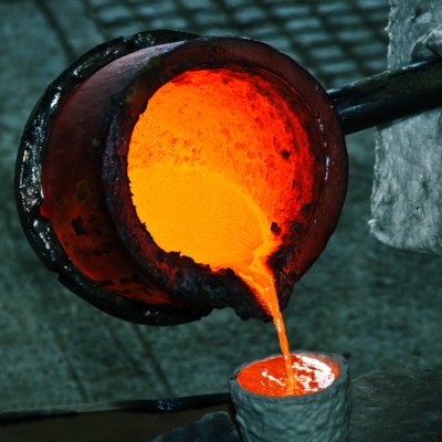 Pouring melted bronze into ceramic shell during lost wax casting
